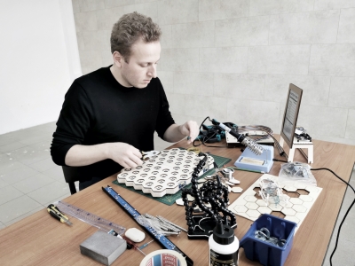 Rohīrs Župēns veido darbu "Tomātu-kartupeļu kalkulators". Foto: Maija Demitere.